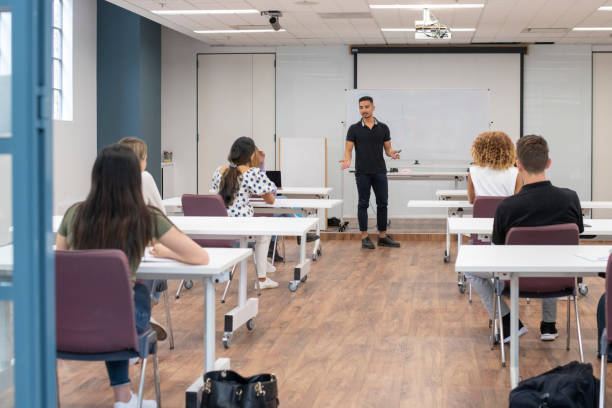 istock Multi-ethnic group of young adults attending lecture 1323601652