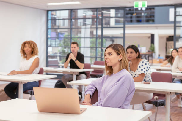 istock Multi-ethnic group of young adults attending lecture 1323601655
