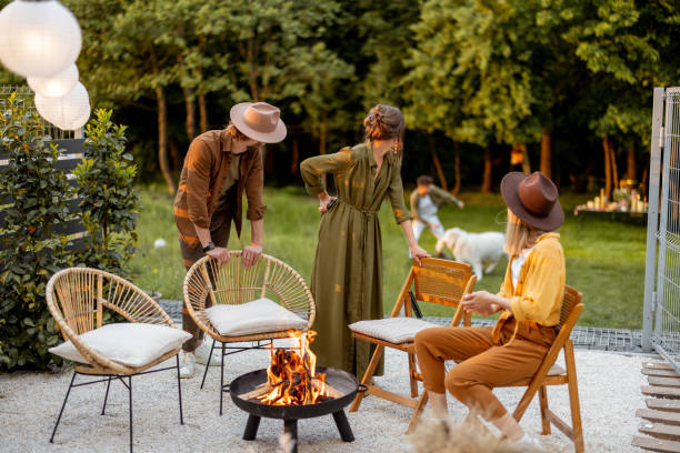 istock Friends sitting by a fireplace at backyard 1323608981