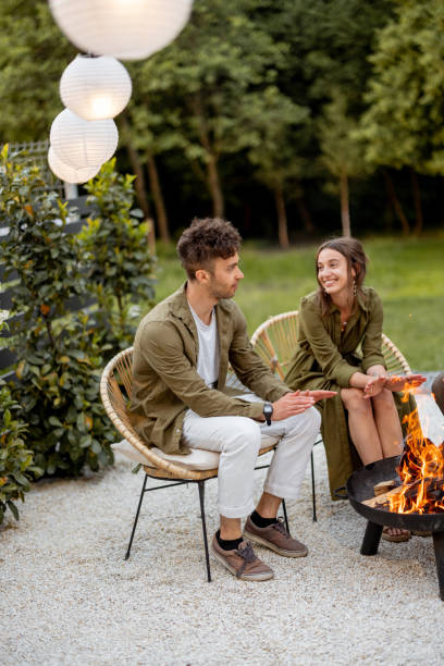istock Friends sitting by a fireplace at backyard 1323608987
