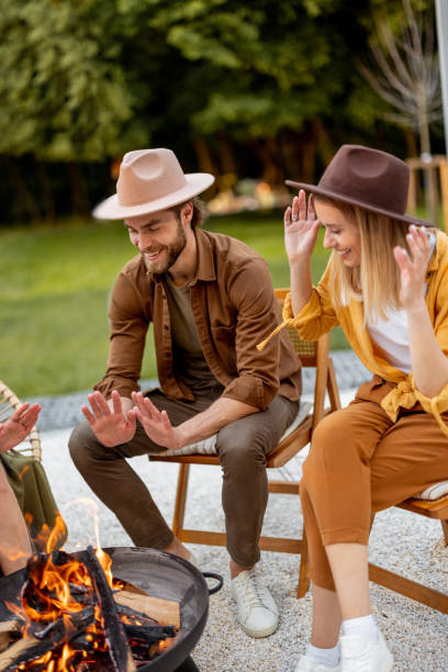 istock Friends sitting by a fireplace at backyard 1323608990