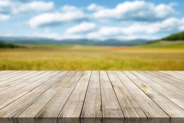 istock Wooden desk on bokeh blur abstract natural background 1323611611