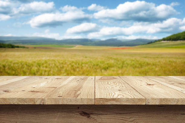 istock Wooden desk on bokeh blur abstract natural background 1323611614
