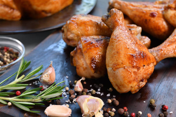 istock Grilled chicken legs with ingredient on wooden cutting board in the kitchen 1323611621