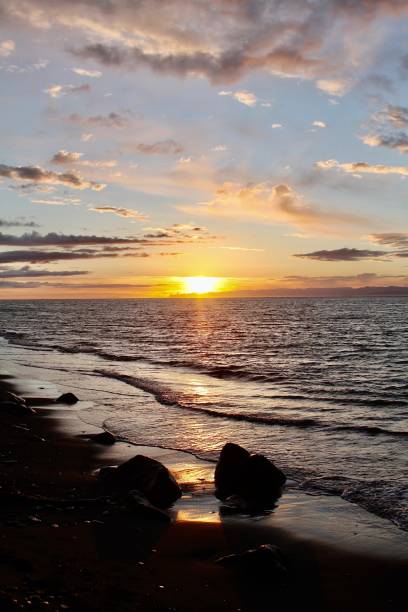 istock Sunset Over The Rocky Shoreline 1323611898
