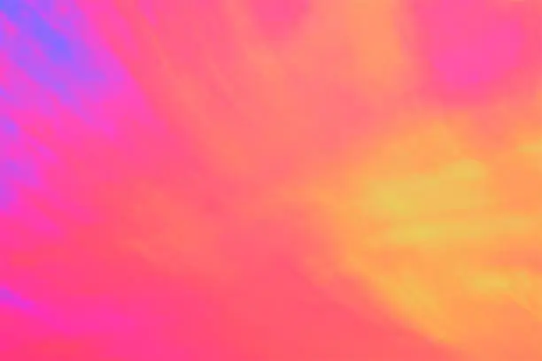 Vibrant multi colored tie dye background of salmon,coral, orange, pink, yellow and blue. Retro tie dye style copy space.