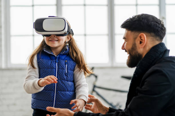 istock Family at home playing with virtual reality headsets. VR. 1323617796