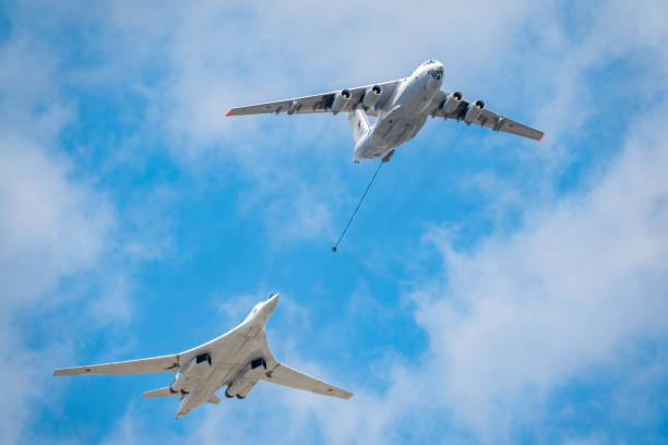 The group of supersonic strategic bomber of long-range aviation Tu-160 and flying tanker Il-78m fly over the Red Square Moscow, Russia - May, 05, 2021: The group of supersonic strategic bomber of long-range aviation Tu-160 and flying tanker Il-78m fly over the Red Square. Tu-160 and IL-78M in the skies over Moscow tu160 stock pictures, royalty-free photos & images