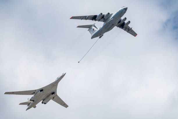 The group of supersonic strategic bomber of long-range aviation Tu-160 and flying tanker Il-78m fly over the Red Square Moscow, Russia - May, 05, 2021: The group of supersonic strategic bomber of long-range aviation Tu-160 and flying tanker Il-78m fly over the Red Square. Tu-160 and IL-78M in the skies over Moscow tu160 stock pictures, royalty-free photos & images