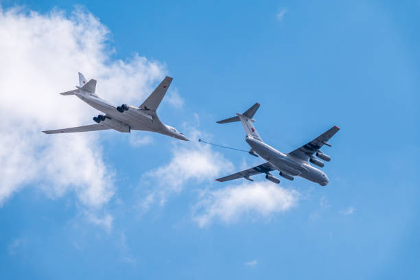 The group of supersonic strategic bomber of long-range aviation Tu-160 and flying tanker Il-78m fly over the Red Square Moscow, Russia - May, 05, 2021: The group of supersonic strategic bomber of long-range aviation Tu-160 and flying tanker Il-78m fly over the Red Square. Tu-160 and IL-78M in the skies over Moscow tu160 stock pictures, royalty-free photos & images