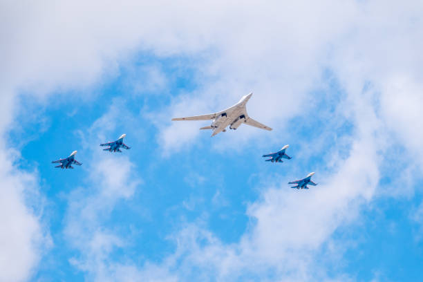 The Tu-160 strategic missile carrier, accompanied by four Su-35S fighter jets, flies over Red Square during the preparation of the May 9 parade. Moscow, Russia - May, 05, 2021: The Tu-160 strategic missile carrier, accompanied by four Su-35S fighter jets, flies over Red Square during the preparation and rehearsal of the May 9 parade. tu160 stock pictures, royalty-free photos & images