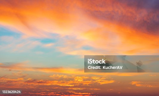 istock Beautiful glowing pink and golden cirrus clouds after storm at sunset, colorful dramatic sunset cloudscape, soft sunlight 1323620424