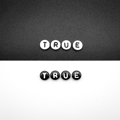 true written with black letters on white and white letters on black abstract concept photo