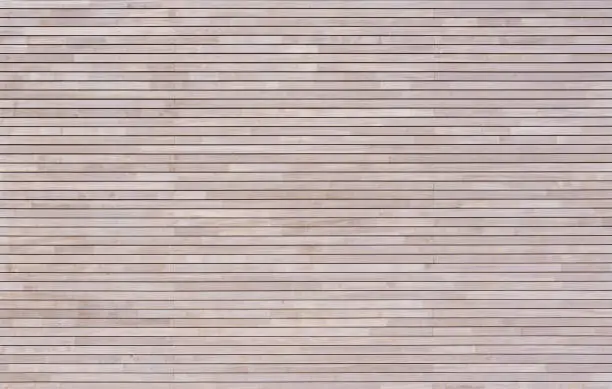 New modern bright wood cladding made of horizontal battens on a facade