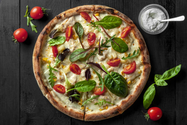 istock Top view of Hawaiian pizza with chicken, pineapple and corn 1323620563
