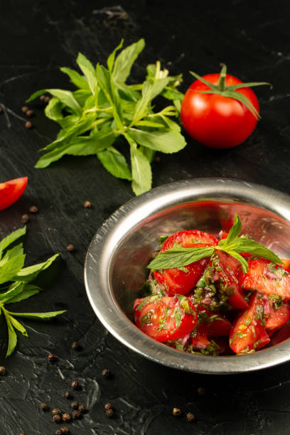 istock Tomatoes salad with greens and mint 1323621634