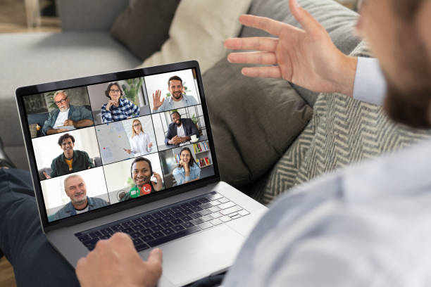 istock Young caucasian man using laptop for having virtual team meeting on video call with different people, work from home office or coworking, online meeting, briefing, brainstorming 1323623426