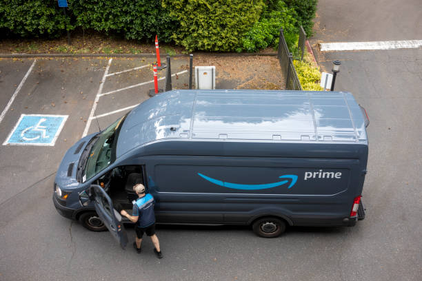 Amazon Delivery Driver Lake Oswego, OR, USA - May 20, 2021: An Amazon delivery driver and his van are seen in a neighborhood parking lot in Lake Oswego, Oregon. amazon.com photos stock pictures, royalty-free photos & images