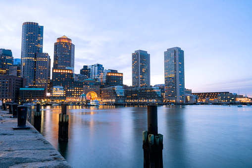 Boston Harbor cityscape from Fan Pier Park riverwalk in Massachusetts, United States sunset moment