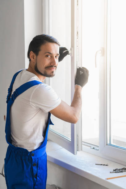 istock Worker installs the window and looks at the camera 1323624850