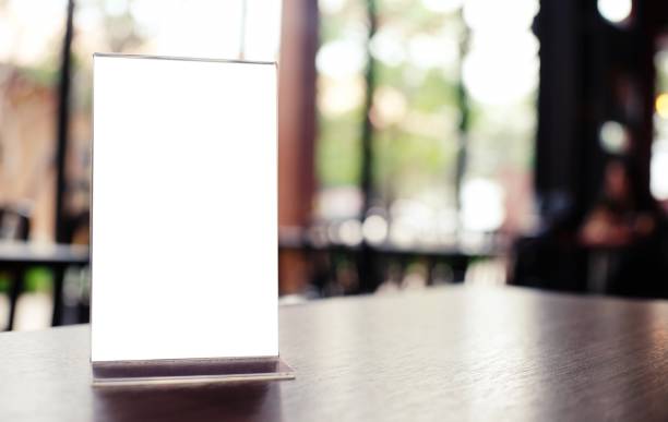 istock Mock up Menu frame standing on wood table in Bar restaurant cafe. space for text 1323625400