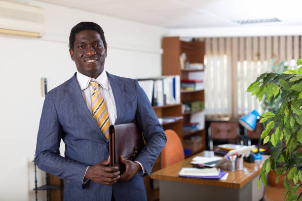 istock Successful african american businessman with briefcase in office 1323626940