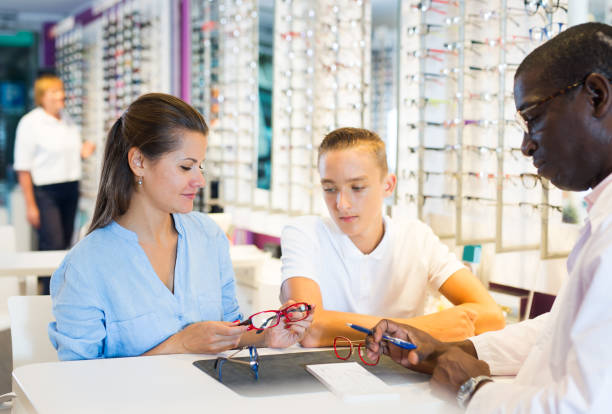 istock Young man and woman clients talking with ophthalmologist 1323627059