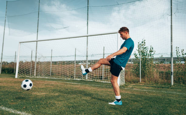 football player playing with soccer ball
