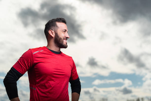 istock Sporty man looking happy and smiling to the side. 1323627622