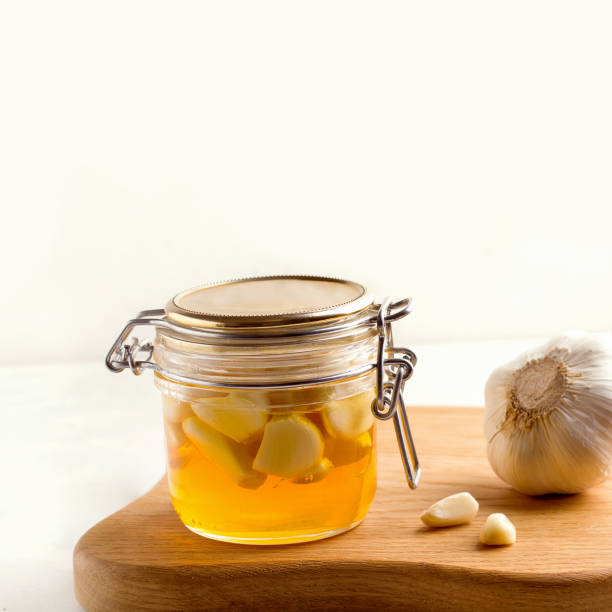 istock Honey with garlic on a white plate next to the ingredients. Copy space 1323627731