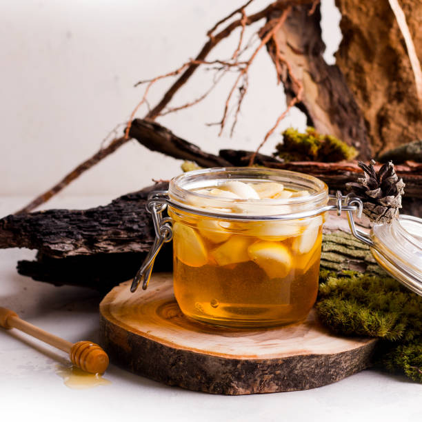 istock Natural honey with garlic on a light background. Fermented food 1323628253