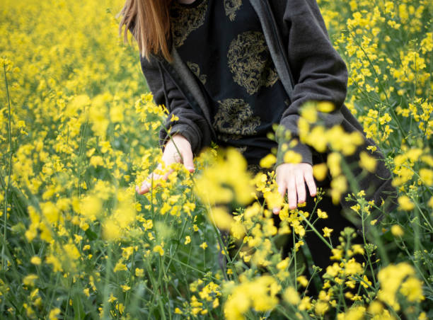 istock Young girl on yellow rapeseed field 1323630641