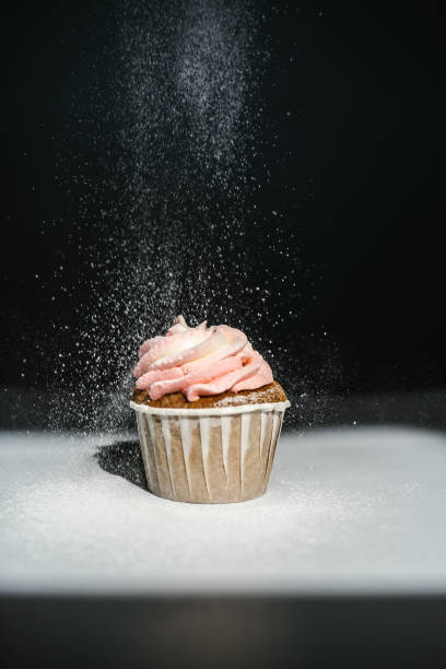 istock Cupcake on a dark background, which is sprinkled on top. 1323630916