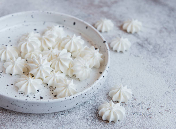 istock Small white meringues in the  ceramic bowl 1323631722