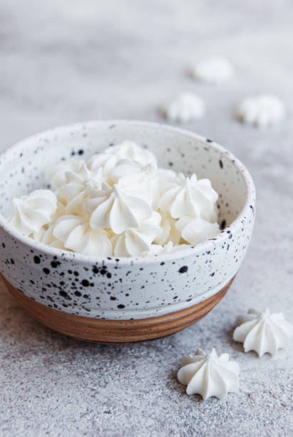 istock Small white meringues in the  ceramic bowl 1323631729