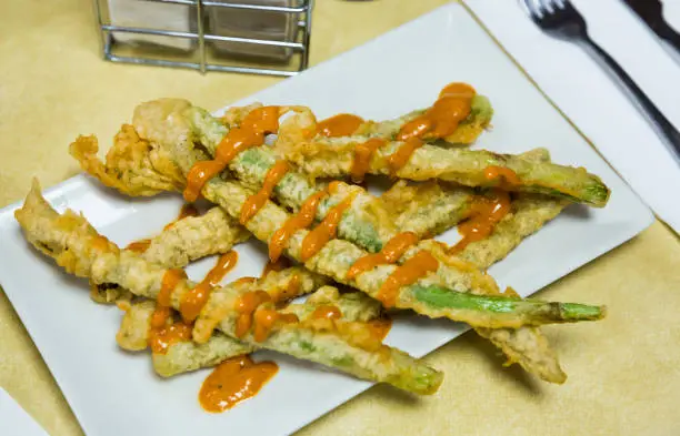 Photo of Asparagus fried in batter with romesco sauce