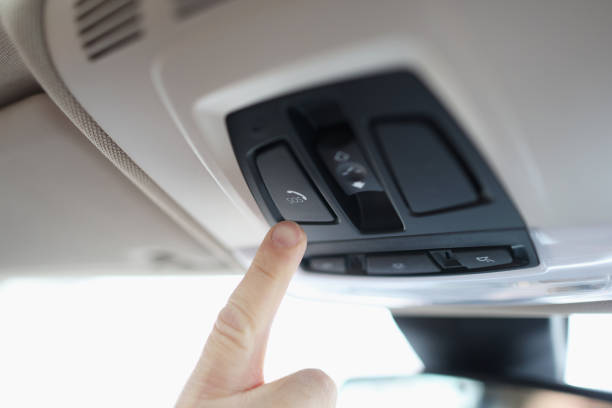 istock Man with his finger pressing emergency button in car closeup 1323635196