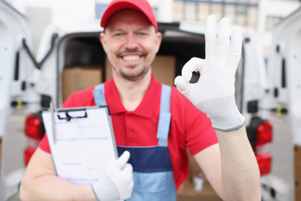 Man courier holding documents and showing okay gesture near car with boxes. High-quality express delivery concept