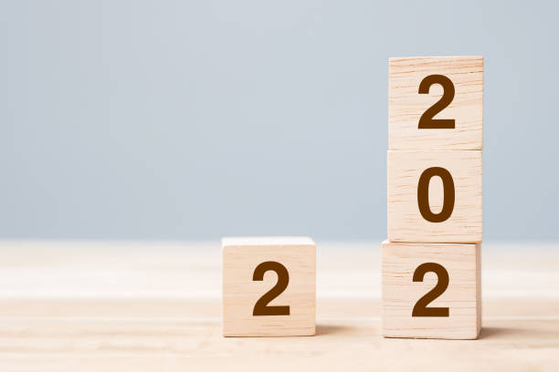 istock 2022 wooden cube blocks on table background. Resolution, plan, review, goal, start and New Year holiday concepts 1323636403
