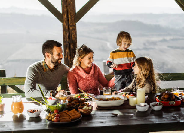 istock Young happy family talking during their lunch on a terrace. 1323637161