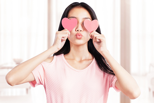 Asian woman holding the red heart at home. Valentines day