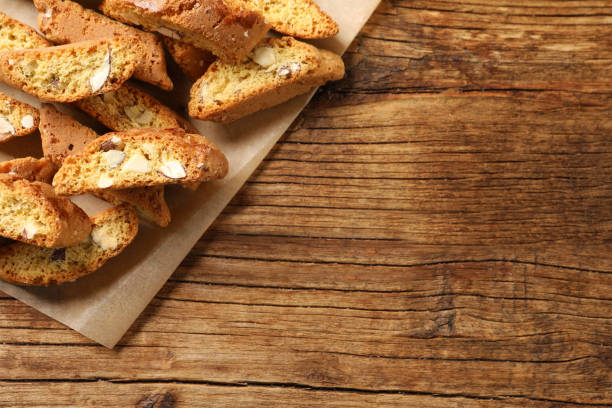 istock Traditional Italian almond biscuits (Cantucci) on white wooden table, flat lay. Space for text 1323639825