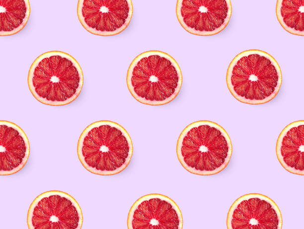 istock Slices of red oranges on pink background, flat lay 1323640939