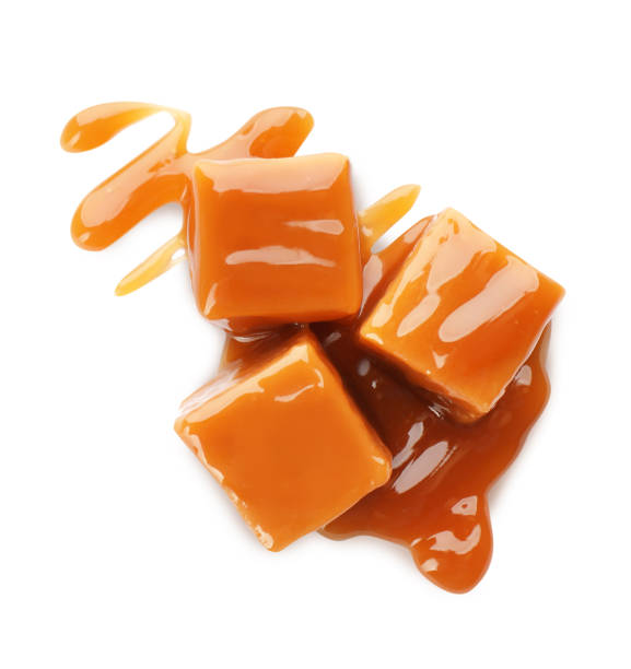 istock Sweet caramel candies with topping isolated on white, top view 1323641027