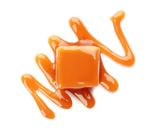 istock Sweet caramel candy with topping isolated on white, top view 1323642397