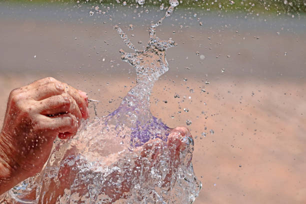 istock Popping a balloon full of water 1323642505