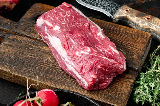 Raw fresh marbled meat black angus steak set, Filet mignon tenderloin cut, on wooden cutting board, on black stone background