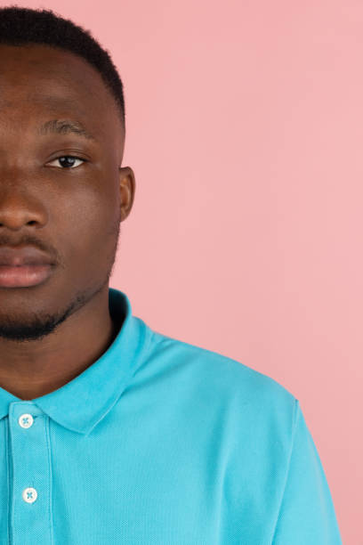 istock African young male portrait isolated on pink studio background with copyspace for ad. 1323644745