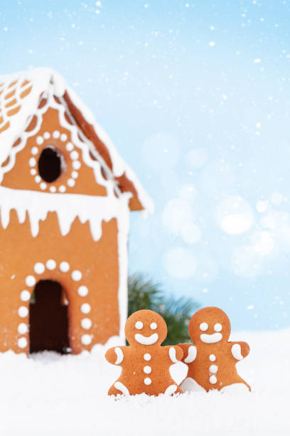istock Christmas greeting card with gingerbread house and man 1323645220