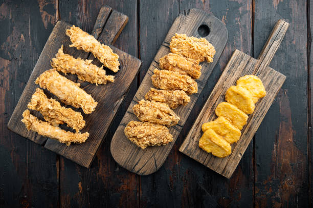 istock Crispy fried chicken on old dark wooden table, flat lay 1323647416